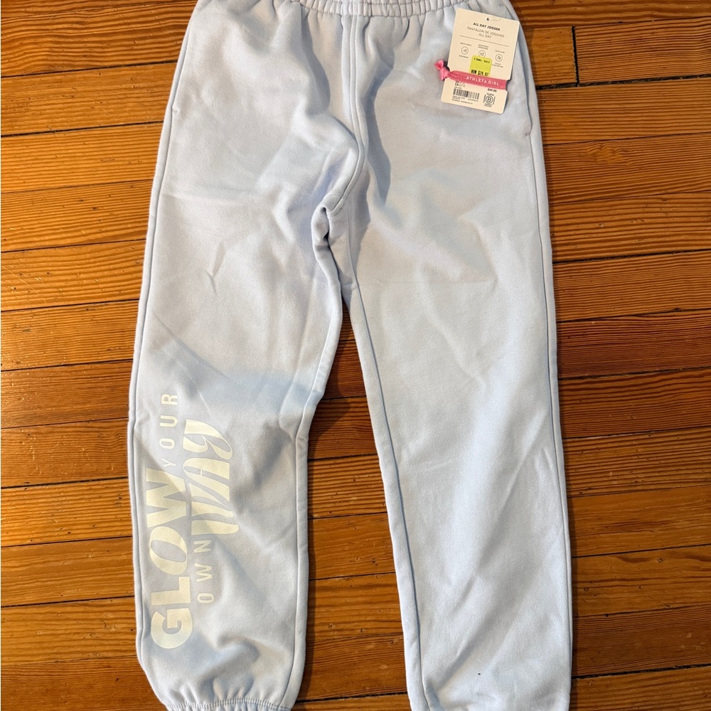 Light Blue Athleta Kids Sweatpants with 'Glow Your Own Way' Graphic